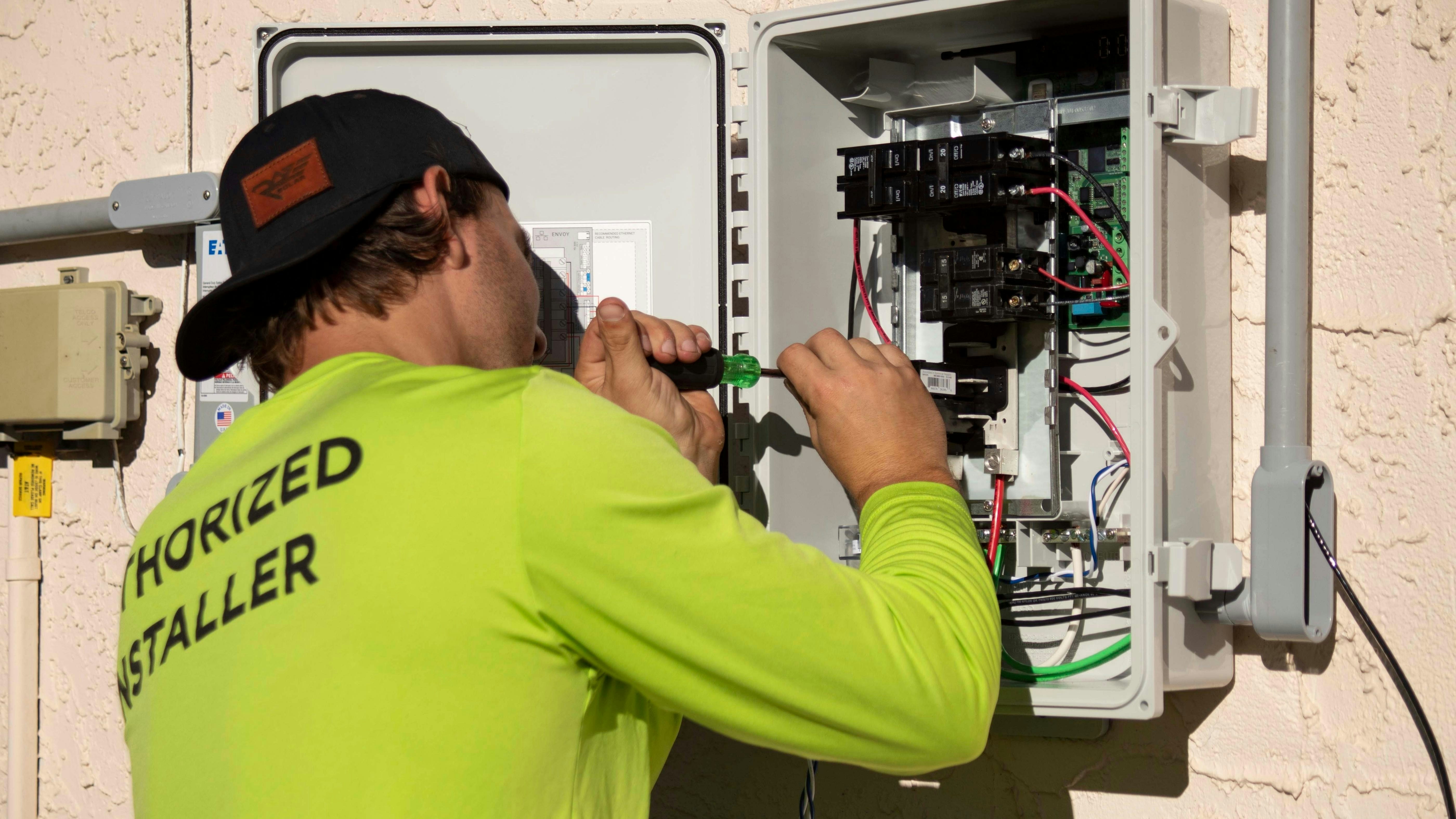 Electrician working on a panel on site.